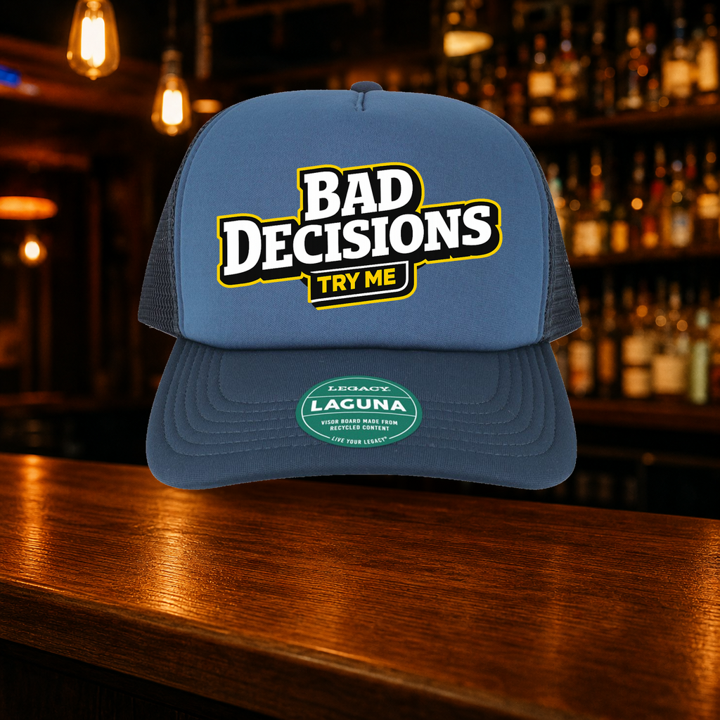 Bad Decisions Try Me Trucker Hat shown against a warm after-dark bar backdrop