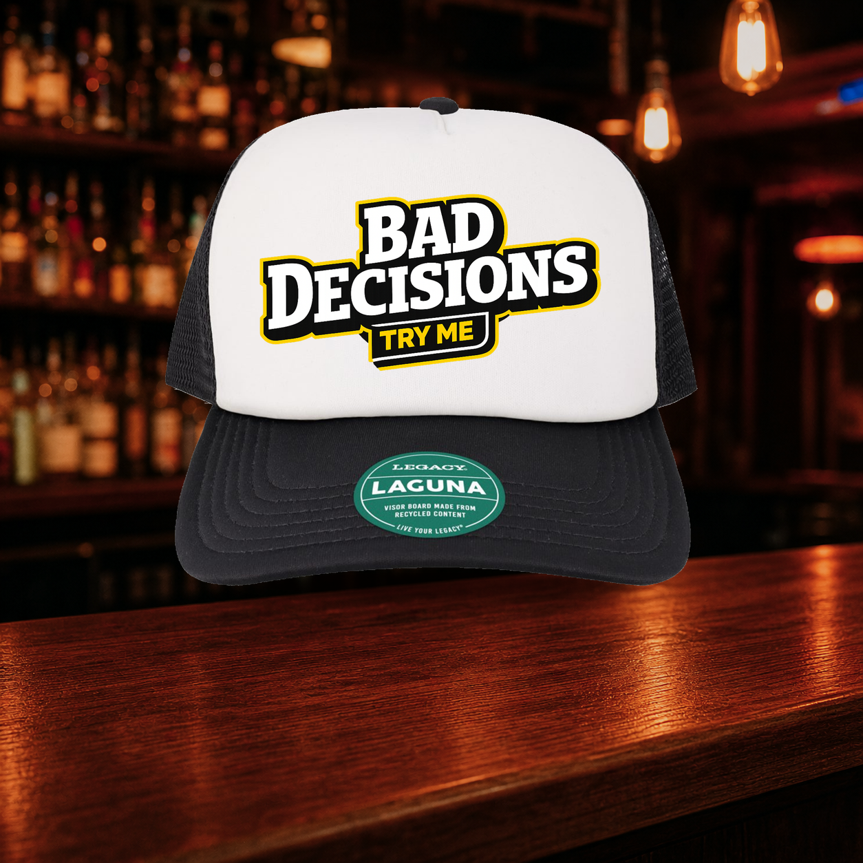 Bad Decisions Try Me Trucker Hat — Black variety shown against a warm after-dark bar backdrop