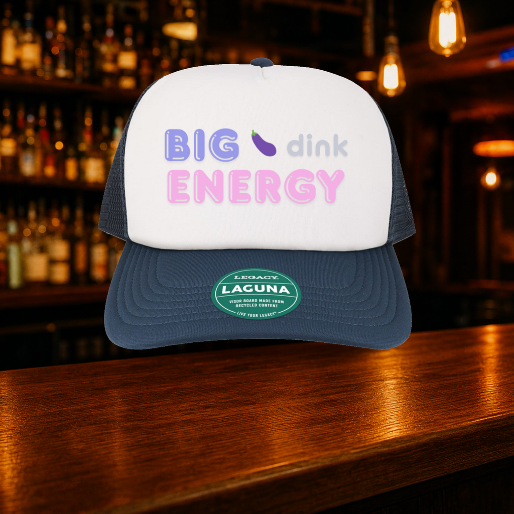 Big Dink Energy Trucker Hat — Navy variety shown against a warm after-dark bar backdrop