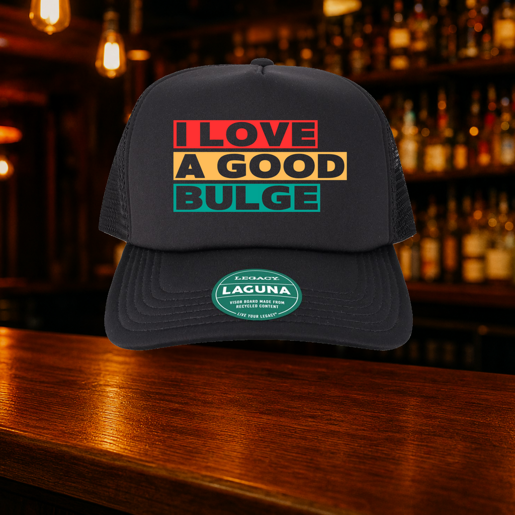 Bulge Trucker Hat shown against a warm after-dark bar backdrop