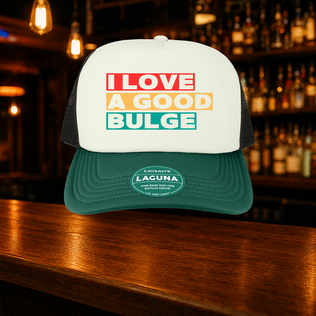 Bulge Trucker Hat — Green variety shown against a warm after-dark bar backdrop