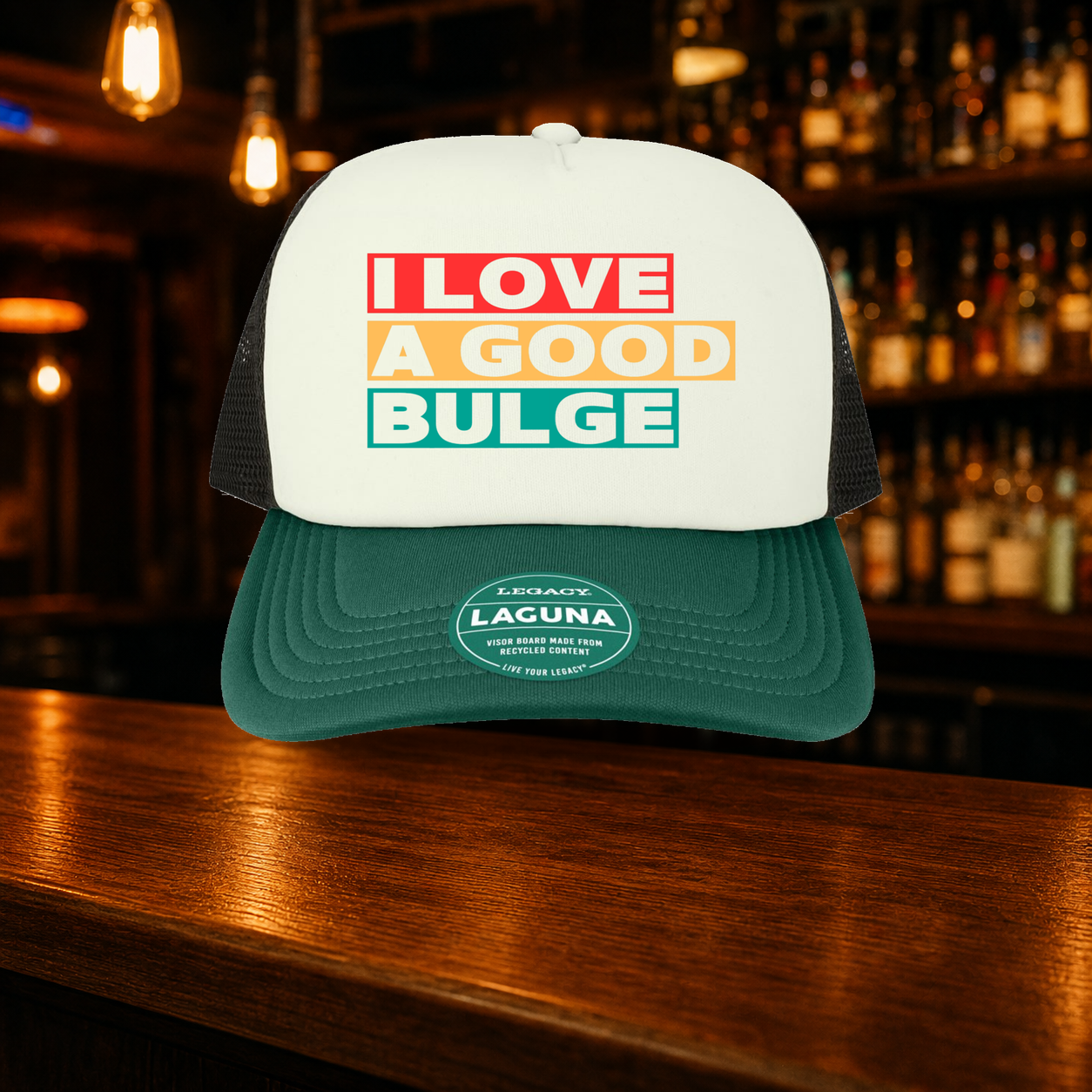 Bulge Trucker Hat — Green variety shown against a warm after-dark bar backdrop