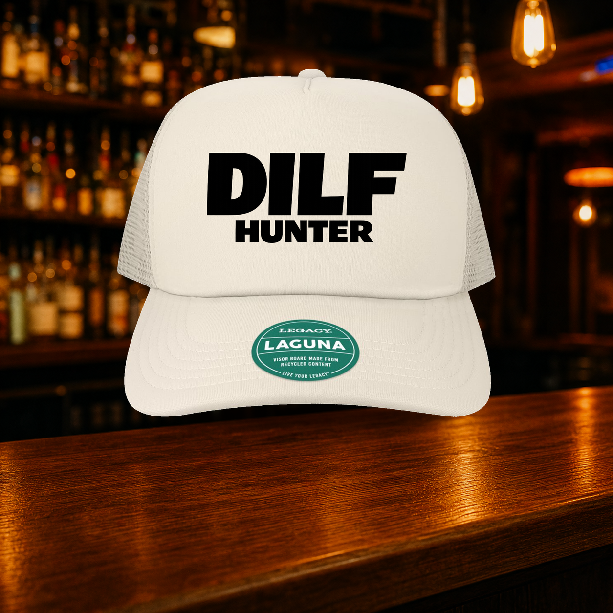 Dilf Hunter Trucker Hat — Beige variety shown against a warm after-dark bar backdrop