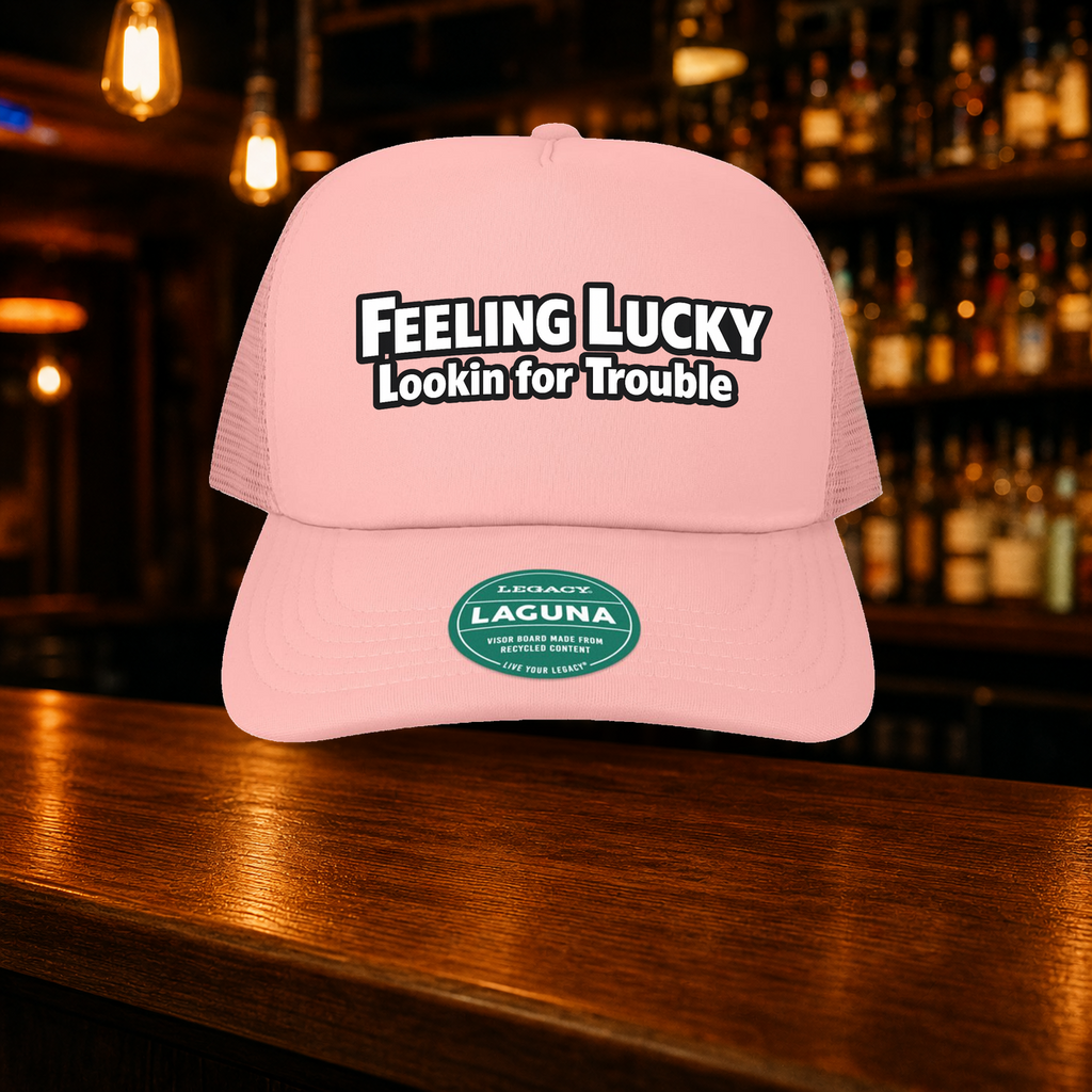 Feeling Lucky Looking for Trouble Trucker Hat shown against a warm after-dark bar backdrop