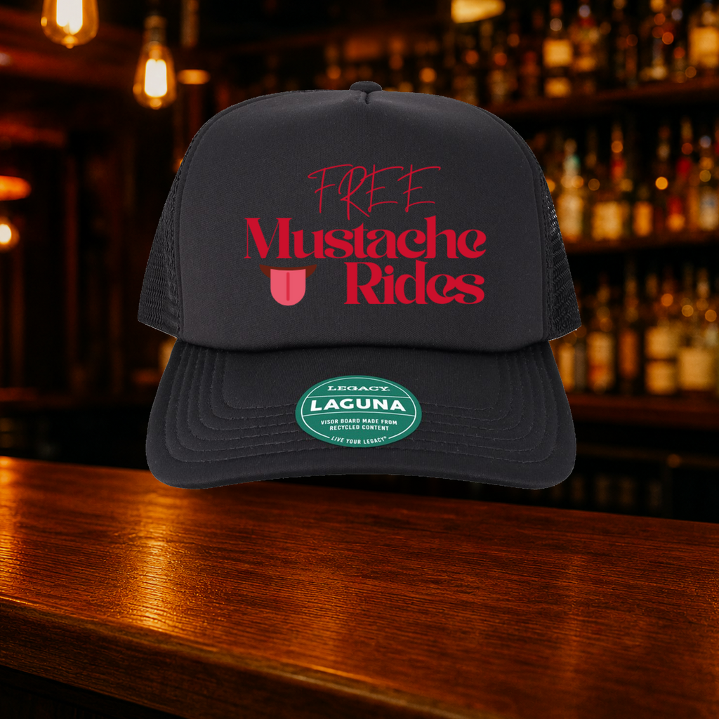 Free Mustache Rides Trucker Hats shown against a warm after-dark bar backdrop