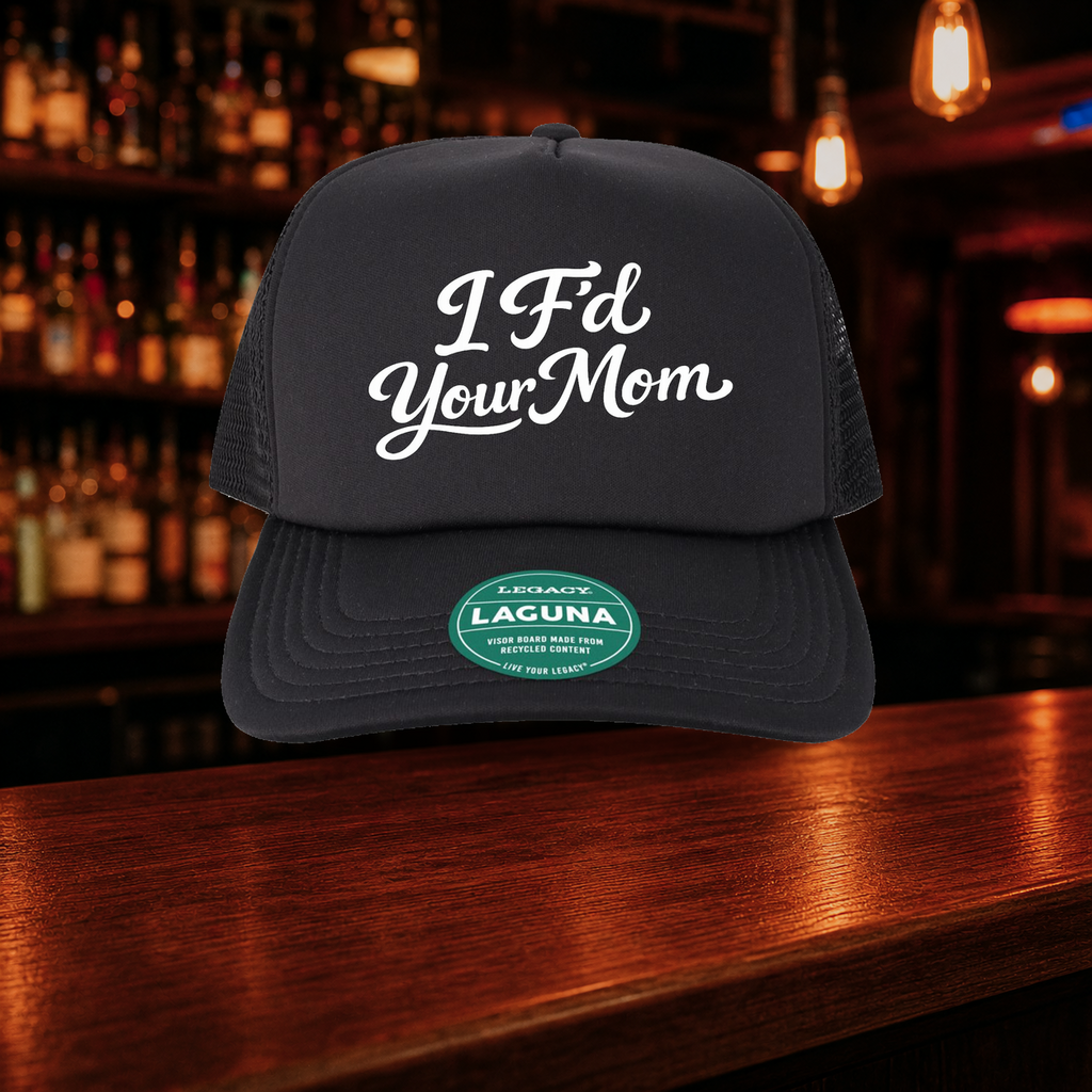 I F'd Your Mom Trucker Hat — All Black variety shown against a warm after-dark bar backdrop