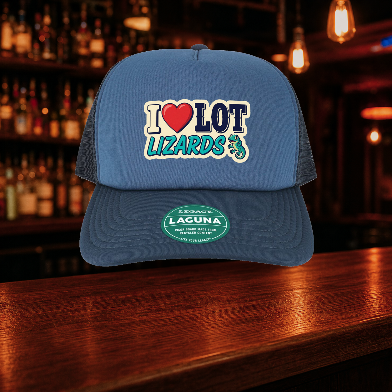 I Love Lot Lizards Trucker Hat — Blue variety shown against a warm after-dark bar backdrop