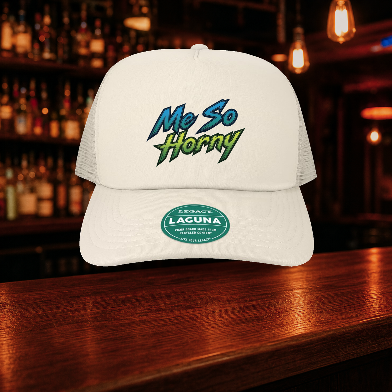 Me So Horny Trucker Hat shown against a warm after-dark bar backdrop