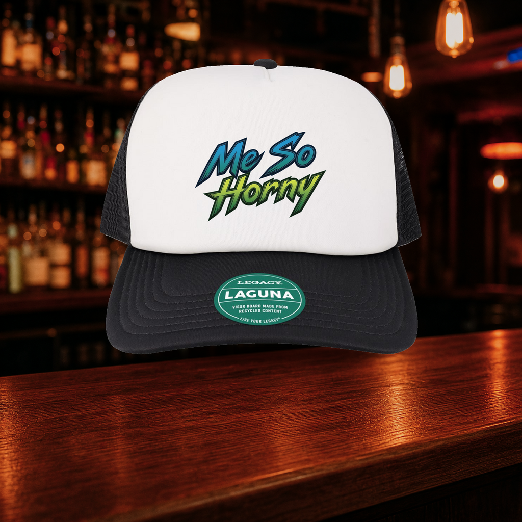 Me So Horny Trucker Hat — Black variety shown against a warm after-dark bar backdrop