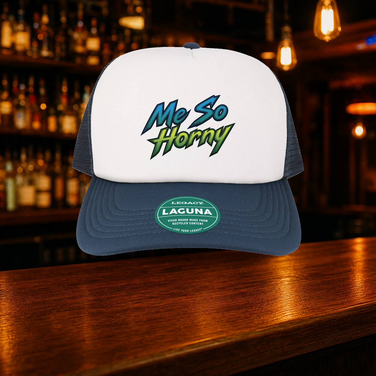 Me So Horny Trucker Hat — Navy variety shown against a warm after-dark bar backdrop