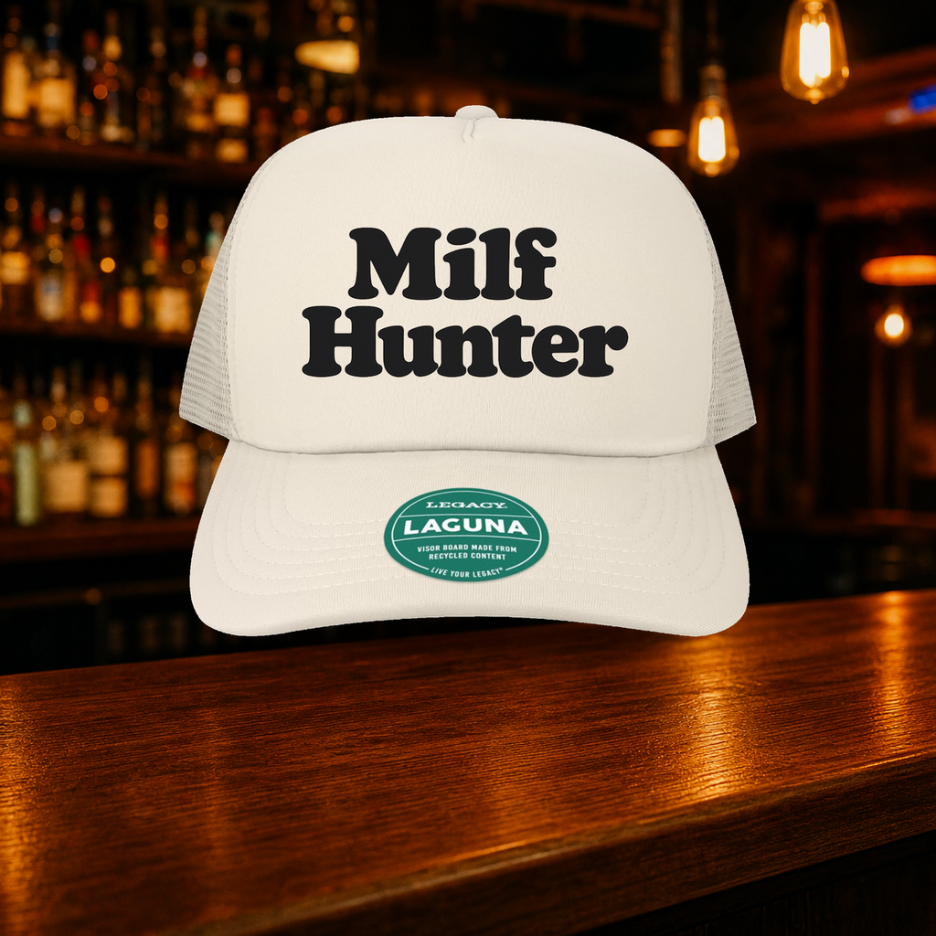 Milf Hunter Trucker Hat — Beige variety shown against a warm after-dark bar backdrop