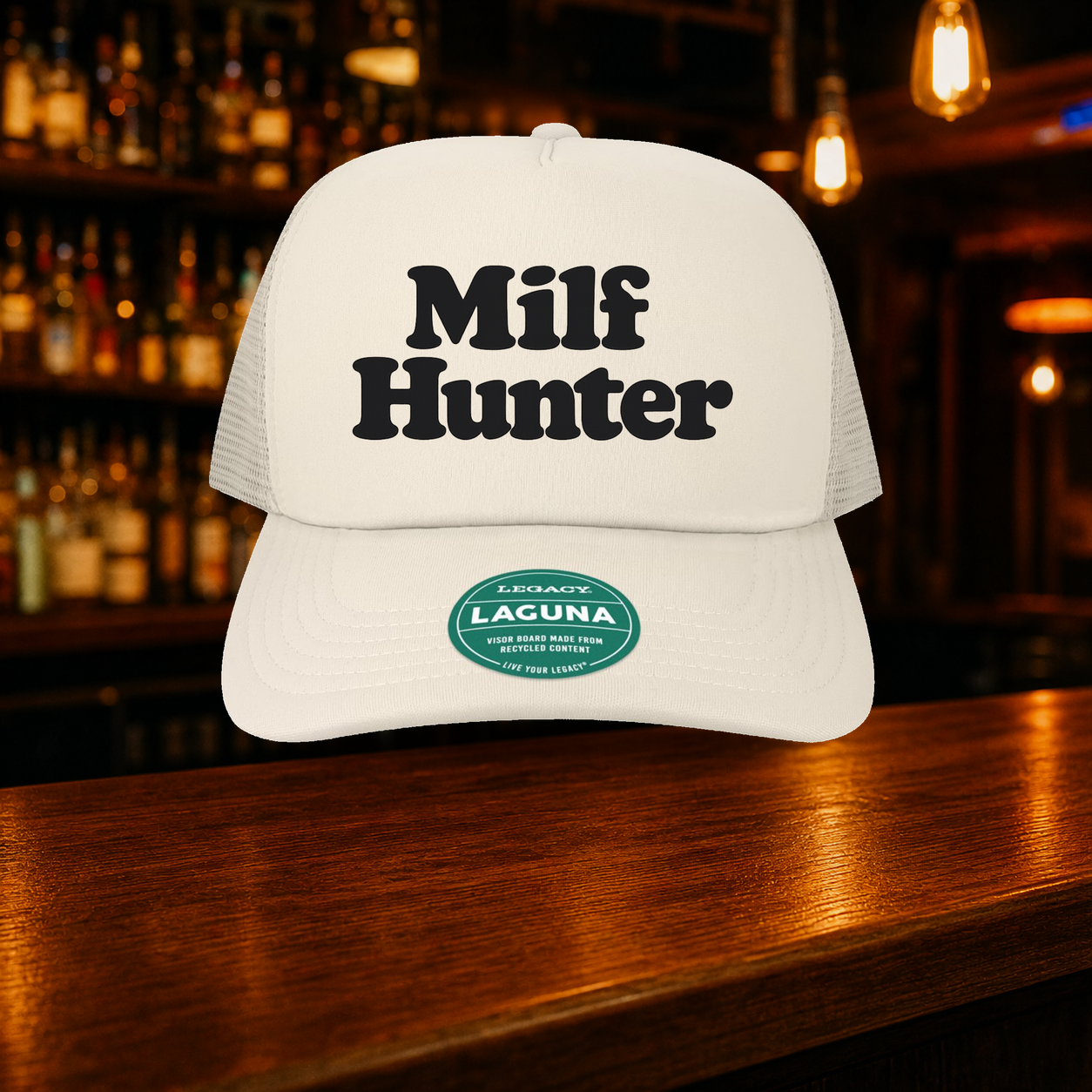 Milf Hunter Trucker Hat — Beige variety shown against a warm after-dark bar backdrop