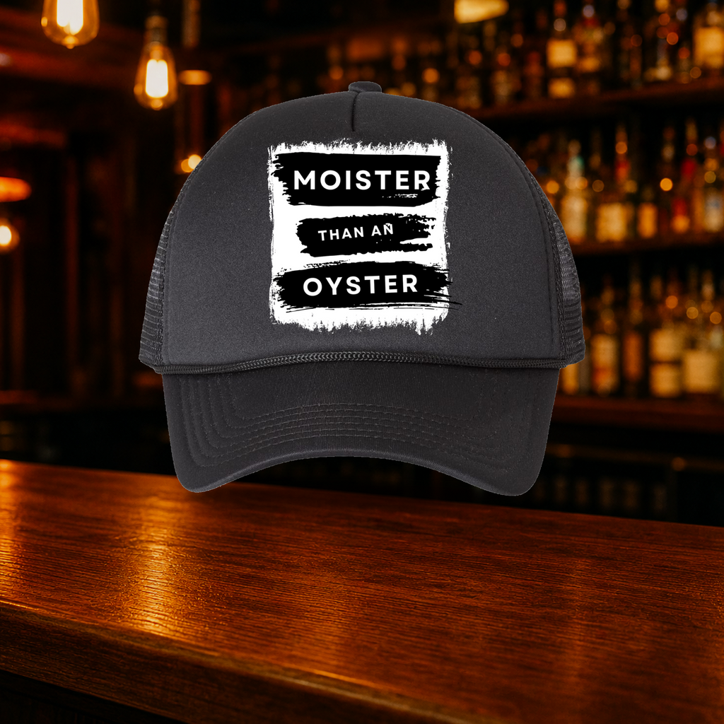 Moister than an Oyster Trucker Hat — All Black variety shown against a warm after-dark bar backdrop