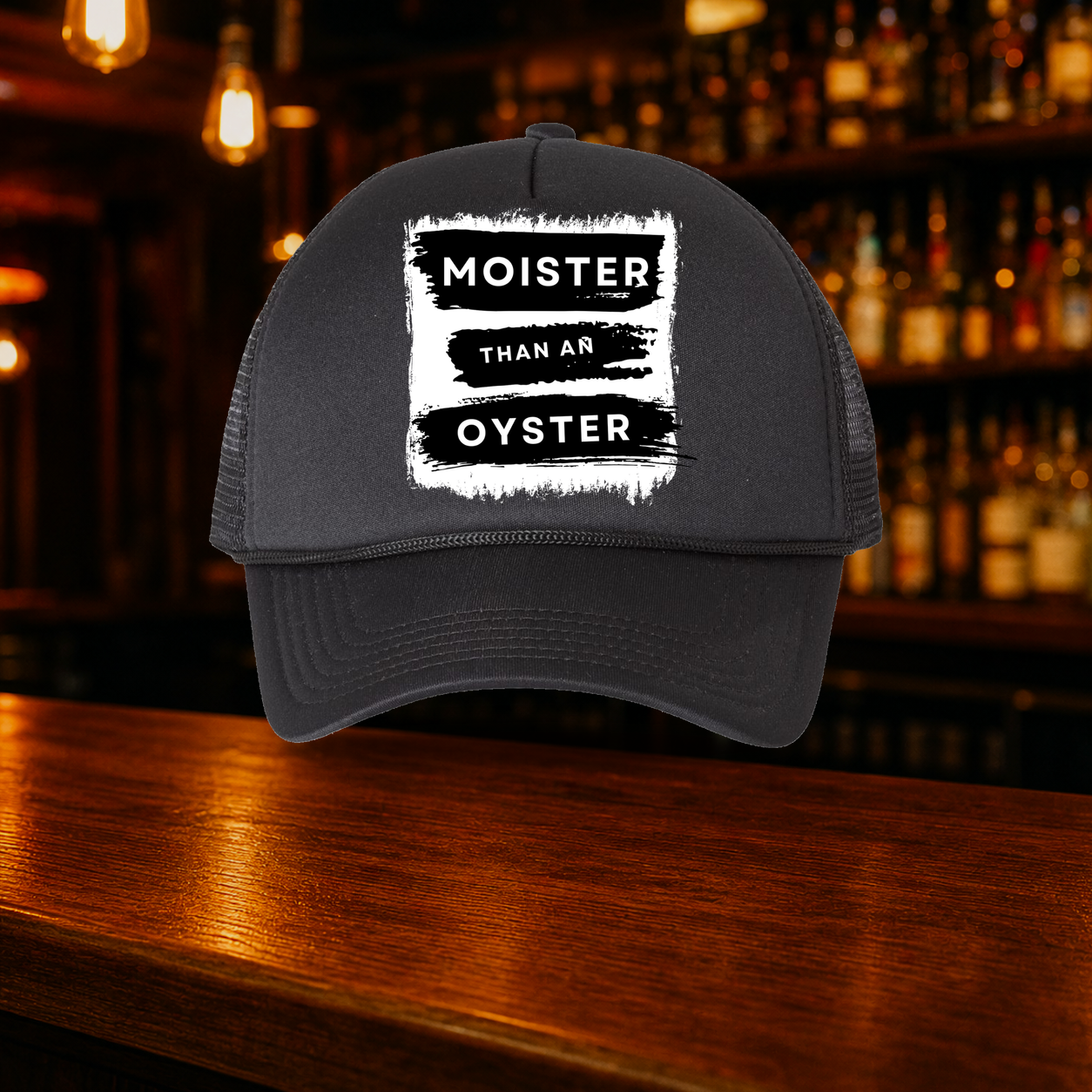 Moister than an Oyster Trucker Hat — All Black variety shown against a warm after-dark bar backdrop