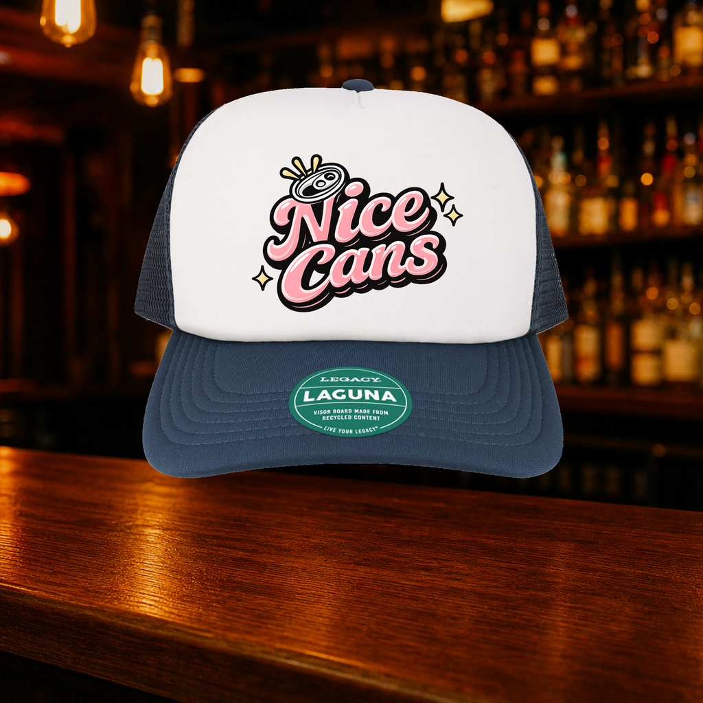 Nice Cans Trucker Hat shown against a warm after-dark bar backdrop