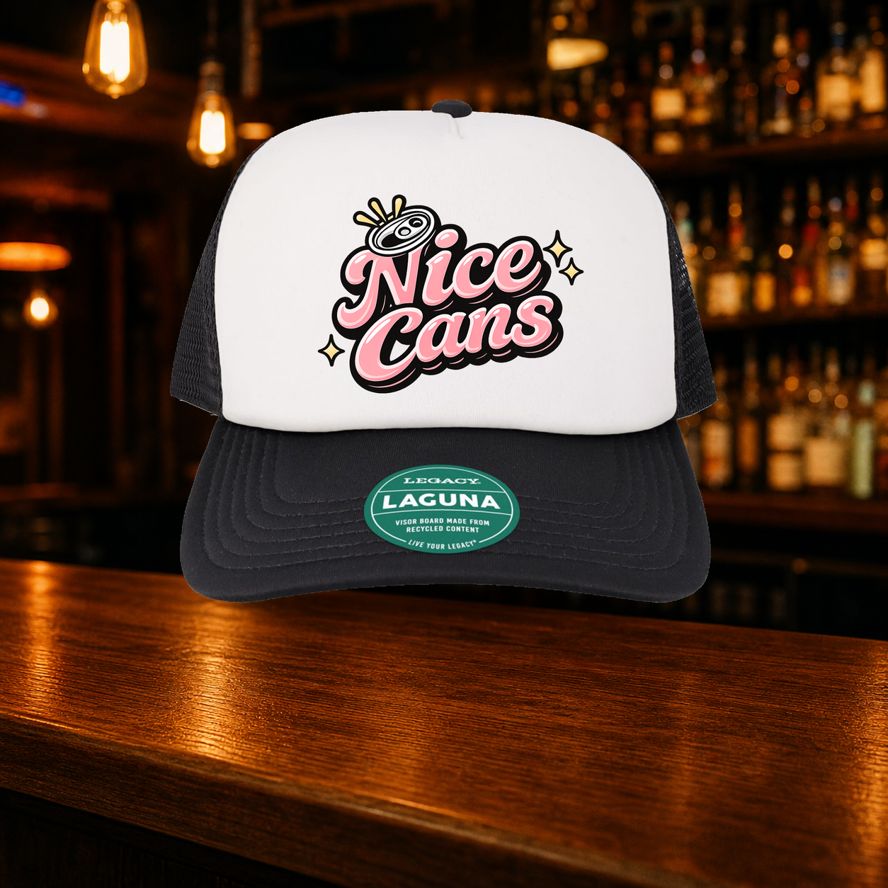Nice Cans Trucker Hat — Black variety shown against a warm after-dark bar backdrop