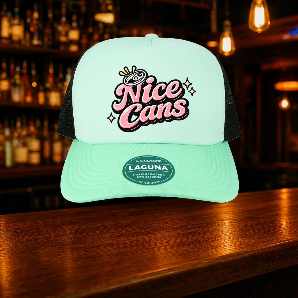 Nice Cans Trucker Hat — Teal variety shown against a warm after-dark bar backdrop