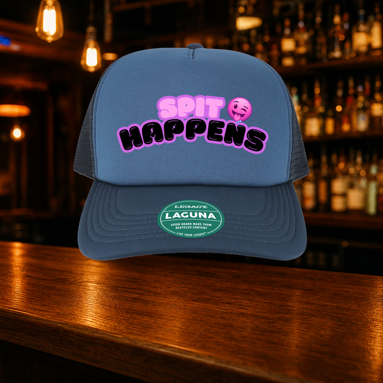 Spit Happens Trucker Hat — Blue variety shown against a warm after-dark bar backdrop
