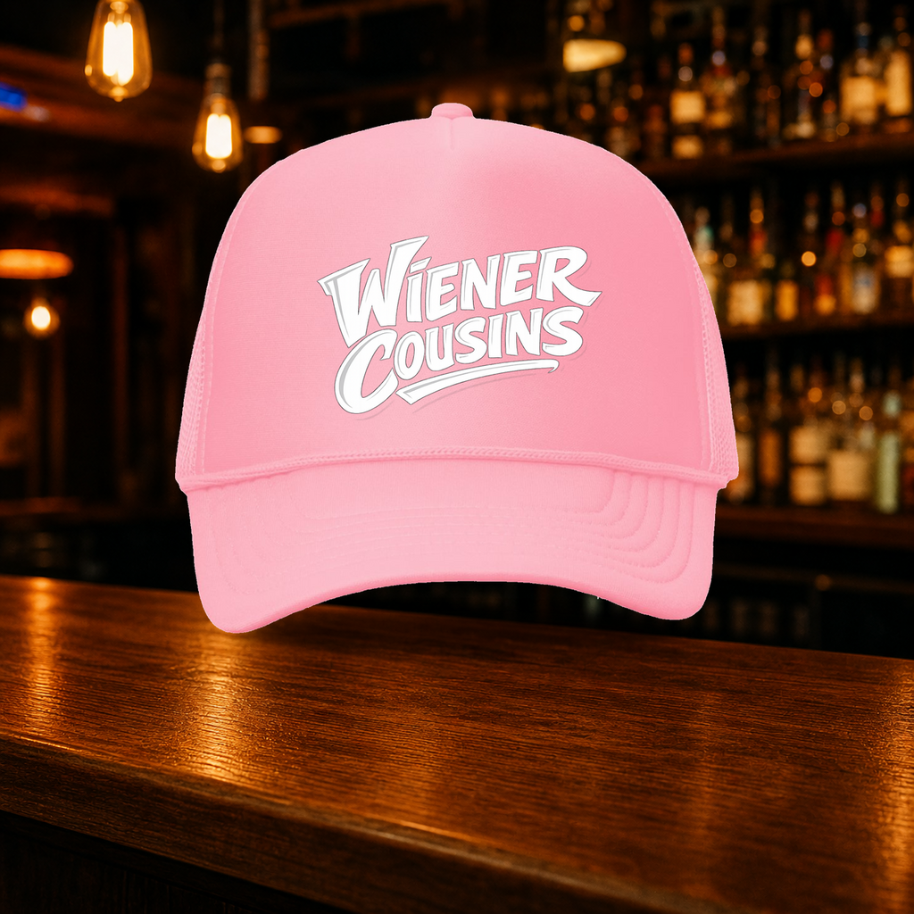 Weiner Cousins Double Snap Trucker Hat — Pink variety shown against a warm after-dark bar backdrop