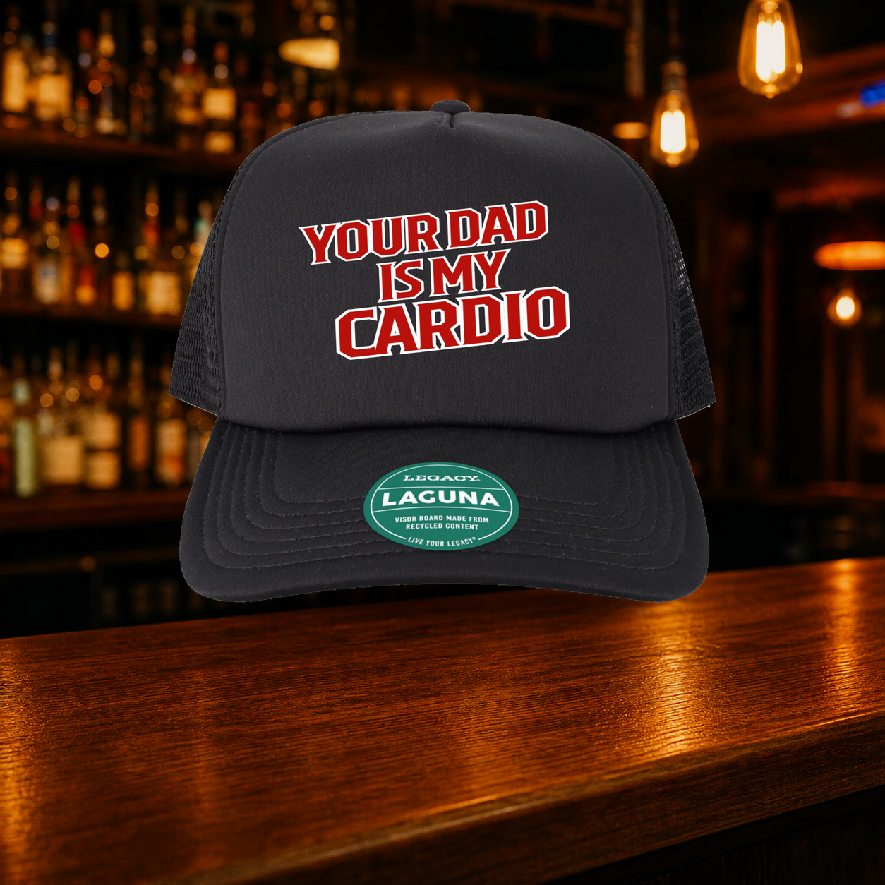 Your Dad is My Cardio Trucker Hat — All Black variety shown against a warm after-dark bar backdrop